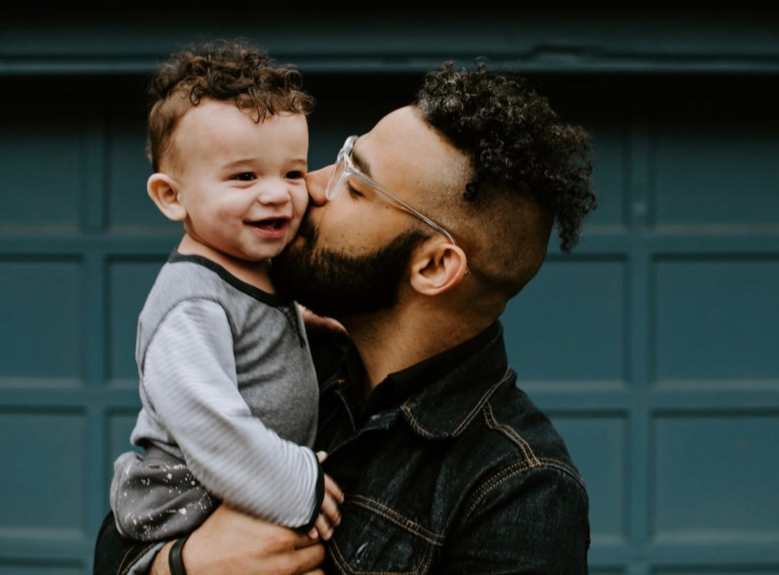 father kissing son