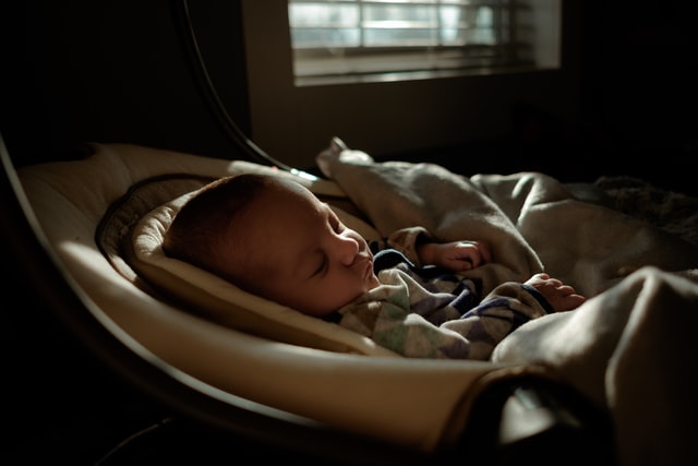 baby having nap in cot