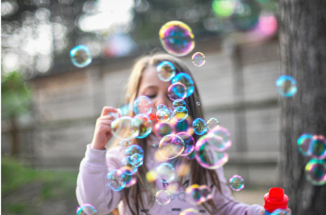 kid blowing bubbles