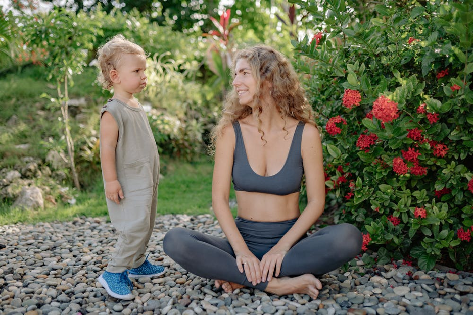 Mother sitting down outside with toddler