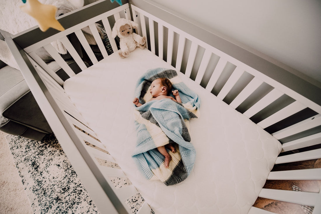 sleeping baby wrapped up in blanket