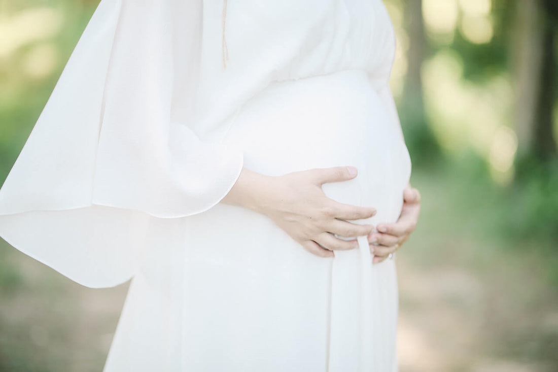 pregnant lady in white dress in summer