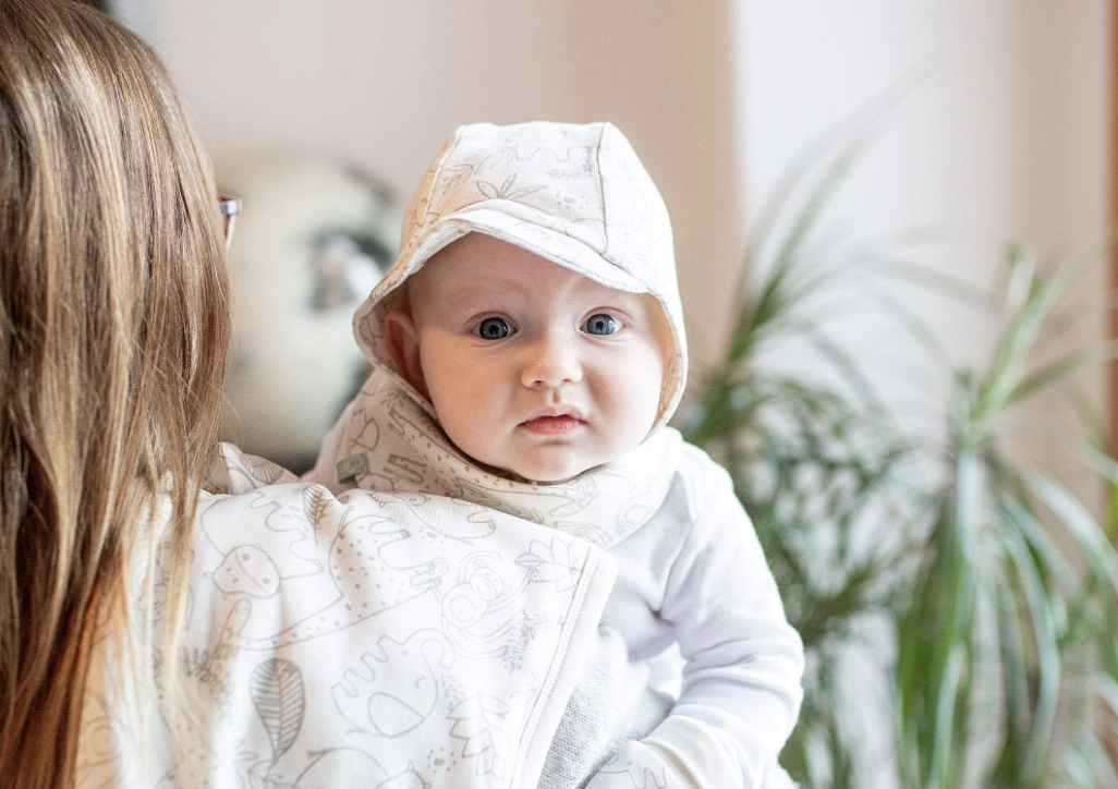baby with burp cloth laying down